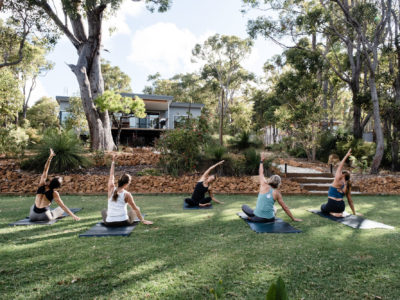 Yoga on the lawn at Bina Maya With Villa in background